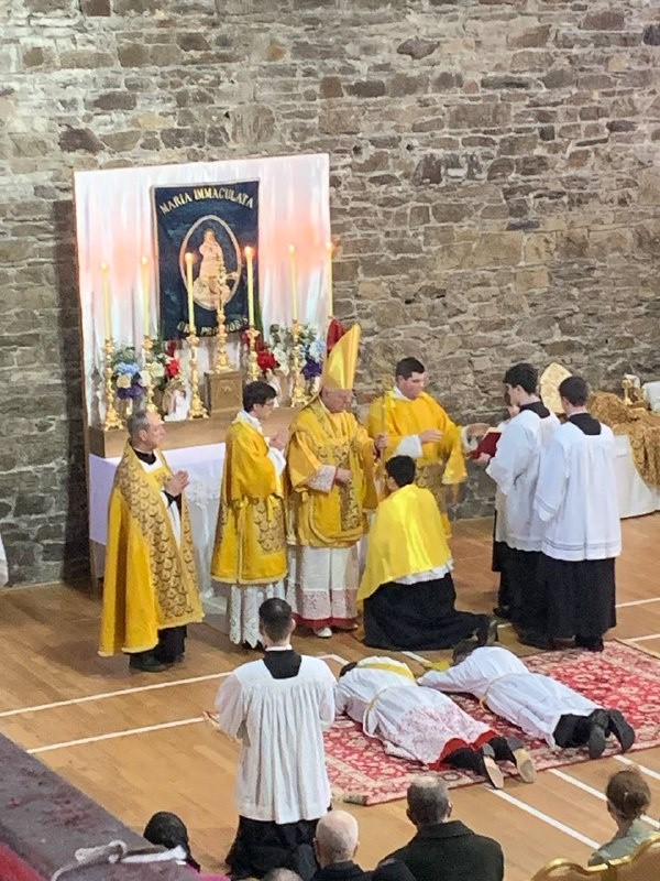 A collection photograph labeled Ordination showing a liturgical ceremony with clergy in gold vestments.